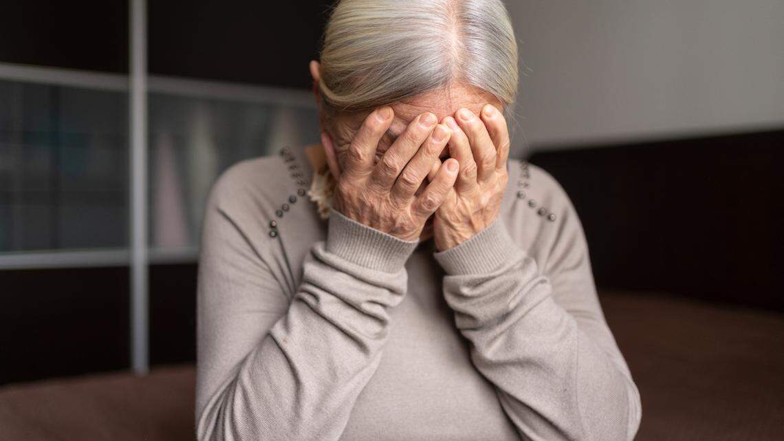 Depressed Senior Woman Covered Her Face With Both Hands