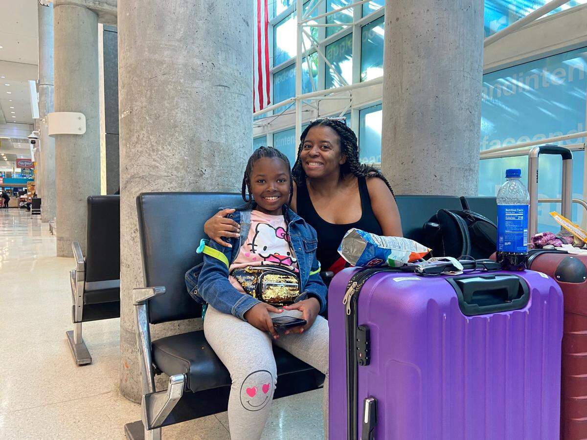 Adrienne Johnson, 10, and her mother, Allison Douglas, wait in the Fort Lauderdale International Airport terminal for an afternoon flight to Philadelphia Friday, April 14, 2023.&nbsp;