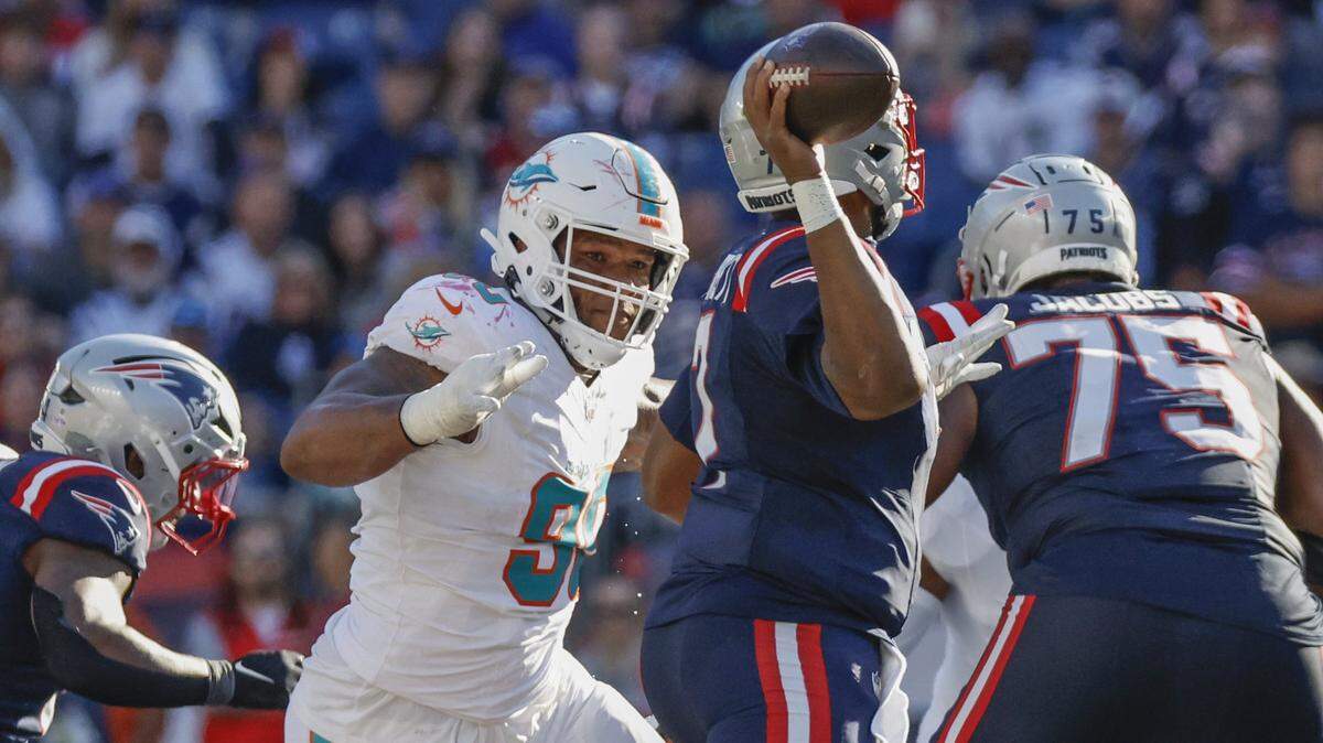 Miami Dolphins Da’Shawn Hand (90) on New England Patriots quarterback Jacoby Brissett (7) in the second half of their NFL football game at Gillette Stadium in Foxborough, Massachusetts on Sunday, October 6, 2024.