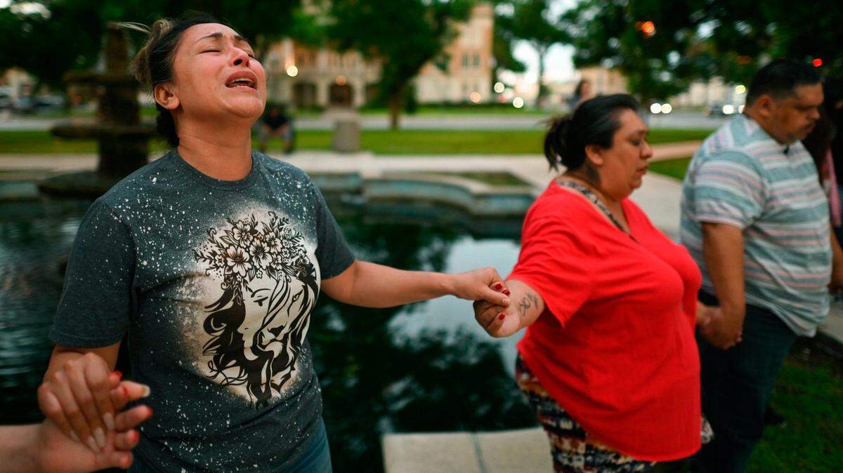 Kladys Castellan prays during a vigil for the victims of a mass shooting at Robb Elementary School in Uvalde, Texas, on Tuesday, May 24, 2022. 