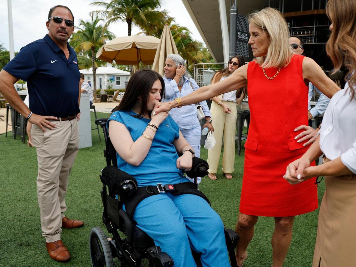 Boating accident survivor Katerina “Katy” Puig kisses the hand of State Representative Vicki Lopez, who co-sponsored ‘Lucy’s Law,’ a new state law that toughens penalties in boat crashes with serious injuries, Bayshore Club in Miami, Florida, on Wednesday, July 2, 2025.