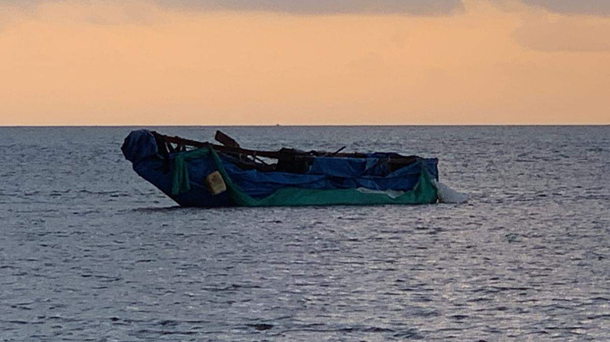 A makeshift vessel sits grounded in the shallow water off Little Duck Key, on the south end of the Seven Mile Bridge, Thursday, Jan. 3, 2018. Twenty-three Cuban men arrived on the boat earlier that morning.