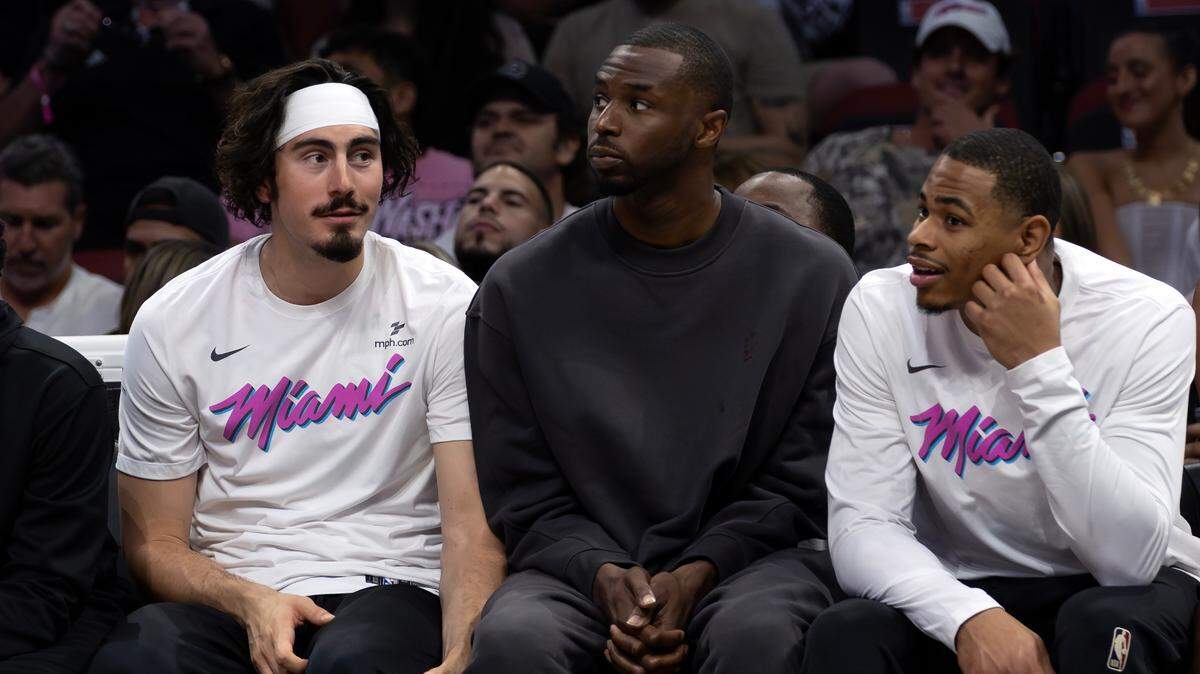 From left to right, Miami Heat guard Jaime Jaquez Jr. (11), forward Andrew Wiggins (22), and forward Keshad Johnson (16) watch from the bench during the first half of their game against the Milwaukee Bucks at Kaseya Center in Miami on April 5, 2025.