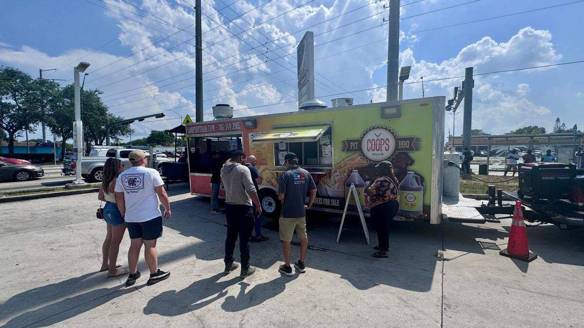 Customers gather at Coop’s BBQ Pit on Wednesday, May 29, 2024 in Miami, Florida. Owned and operated by brothers Torris, Rhaudal Jr. and Kelvin Cooper as well as their father Rhaudal Cooper Sr., Coop’s BBQ Pit received the Keith Lee stamp of approval thanks to the food blogger’s review that was posted Tuesday on TikTok.