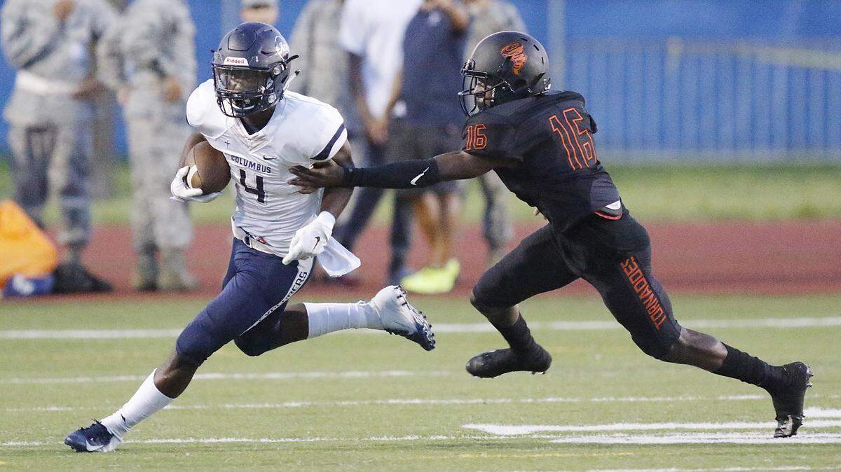 Columbus Explorers’ Henry Parrish (4) runs the ball against the Booker T. Washington Tornadoes during the football game on Friday, Sept. 14, 2018 at Curtis Park Stadium in Miami.