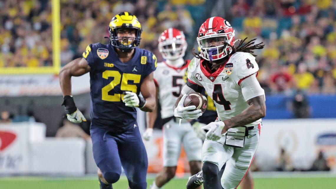 Georgia Bulldogs running back James Cook (4) scores in the fourth quarter against Michigan Wolverines during the 2021 College Football Playoff Semifinal at the Capital One Orange Bowl hosted at Hard Rock Stadium in Miami Gardens, Florida, on Friday, December 31, 2021.