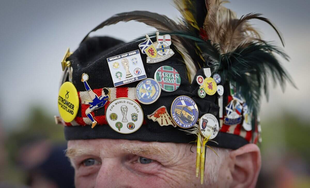 Iain Ness of Scotland displays his Tartan Army pins during the parade along Ocean Drive on Miami Beach on Tuesday, June 23, 2026.