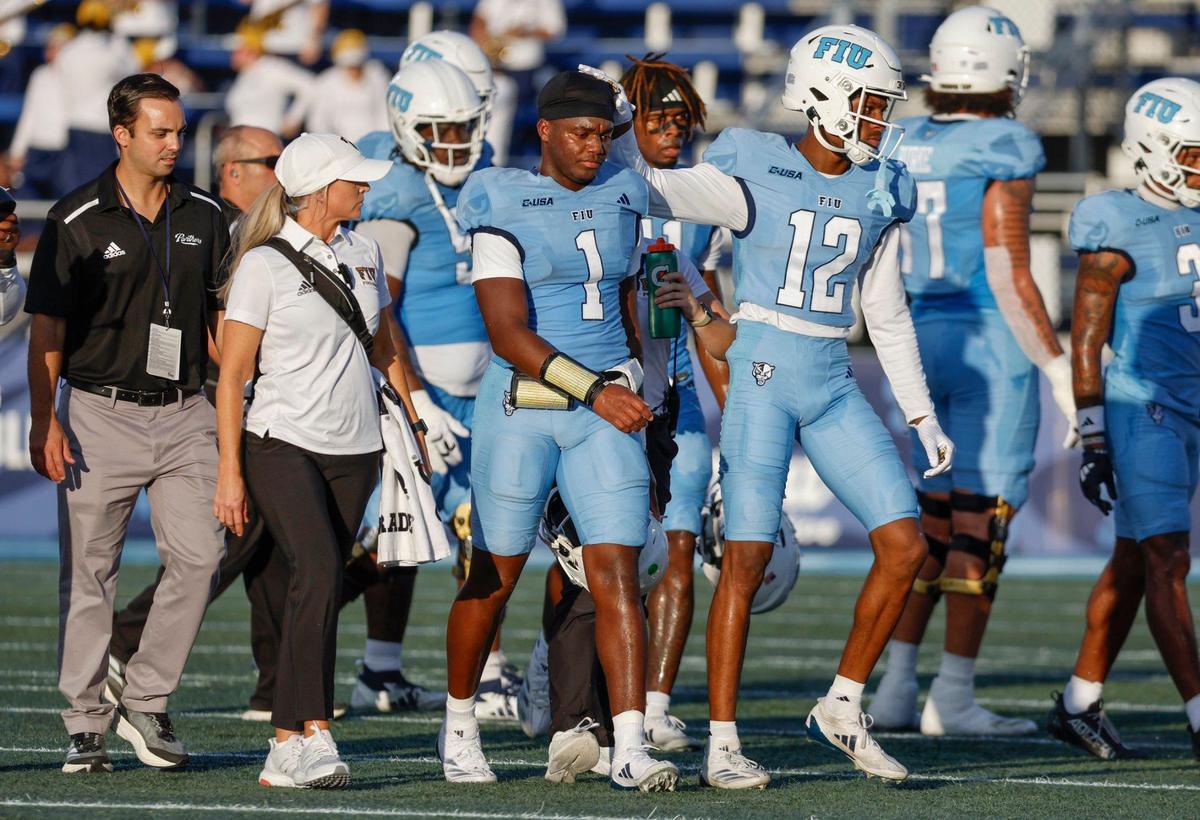 Florida International University Panthers quarterback Keyone Jenkins (1) is escorted off the field after a possible injury during the game against the Louisiana Tech Bulldogs in the first half of an NCAA conference football game at Pitbull Stadium on Saturday, September 28, 2024, in Miami, Fla.