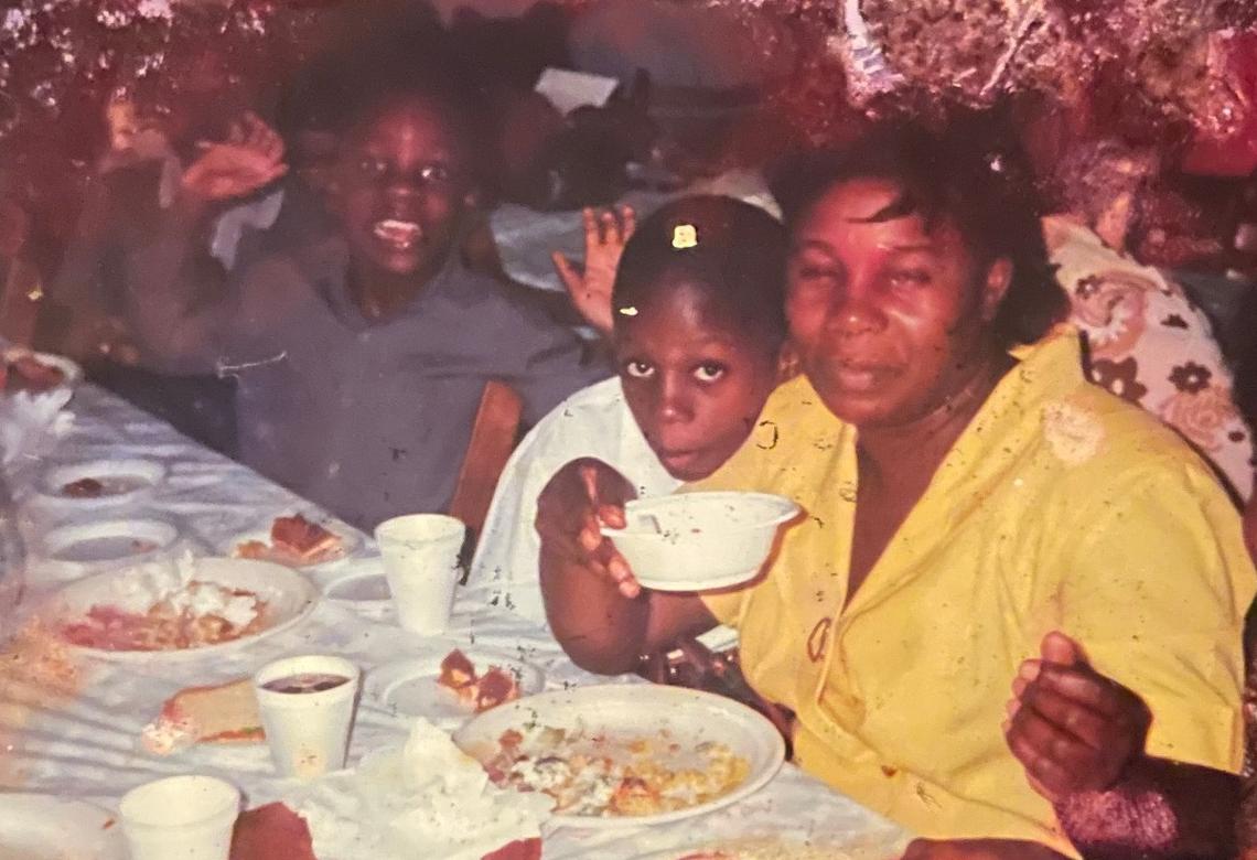 Emmanuel Jean, 8, poses for a photo in 1995 with his brother Nahum Jean, 7, left, and his mother Yolette Jean, right, during a church event.