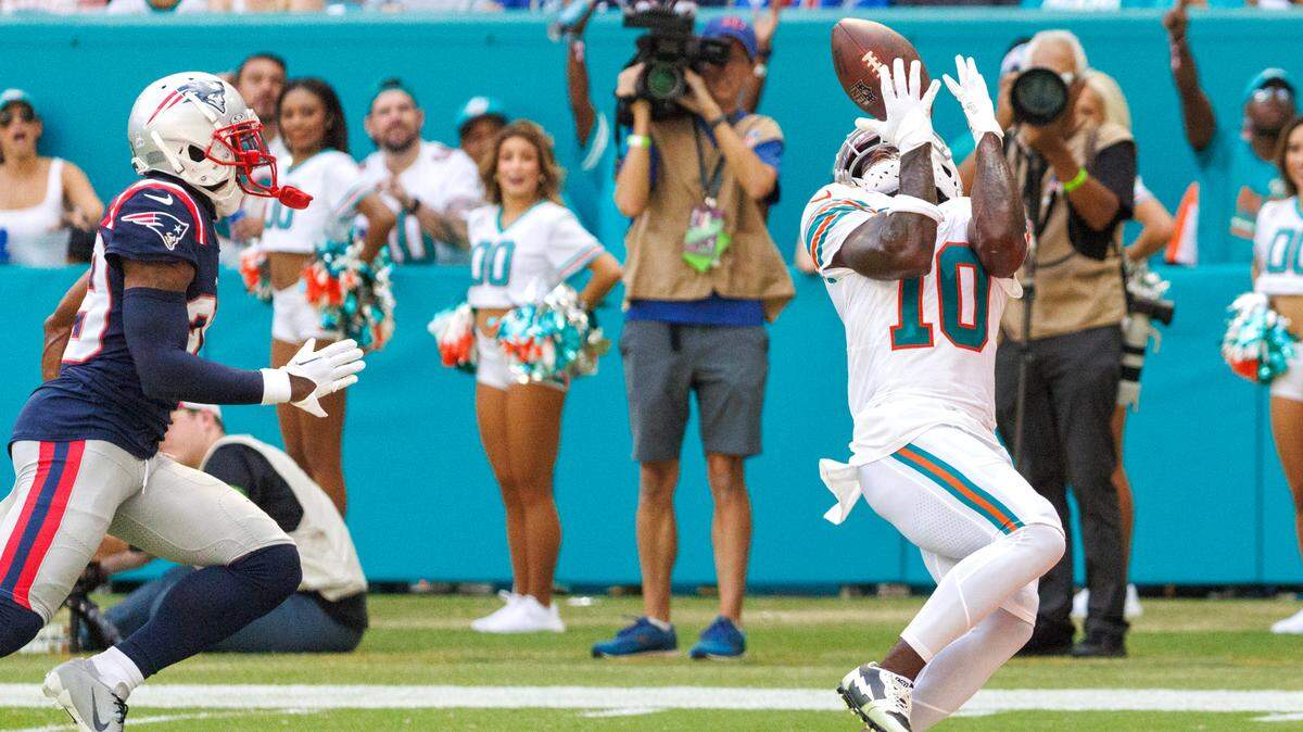 Miami Dolphins wide receiver Tyreek Hill (10) catches a pass for a touchdown New England Patriots cornerback J.C. Jackson (29) defends during first quarter of an NFL football game at Hard Rock Stadium on Sunday, Oct. 29, 2023 in Miami Gardens, Fl.