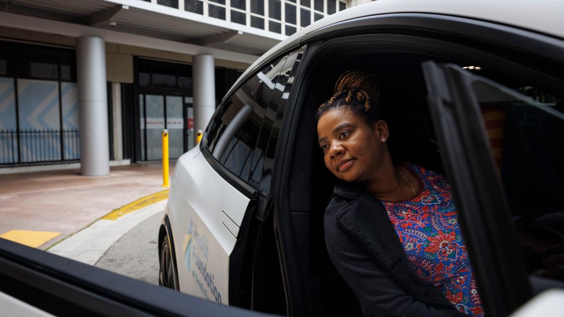 Marie Odvil uses a free car service for low-income pregnant mothers provided by Green Cars For Kids in partnership with Freebee and Jackson Health on Wednesday, Aug. 28, 2024, outside of Holtz Children’s Hospital on Jackson’s campus in Miami.