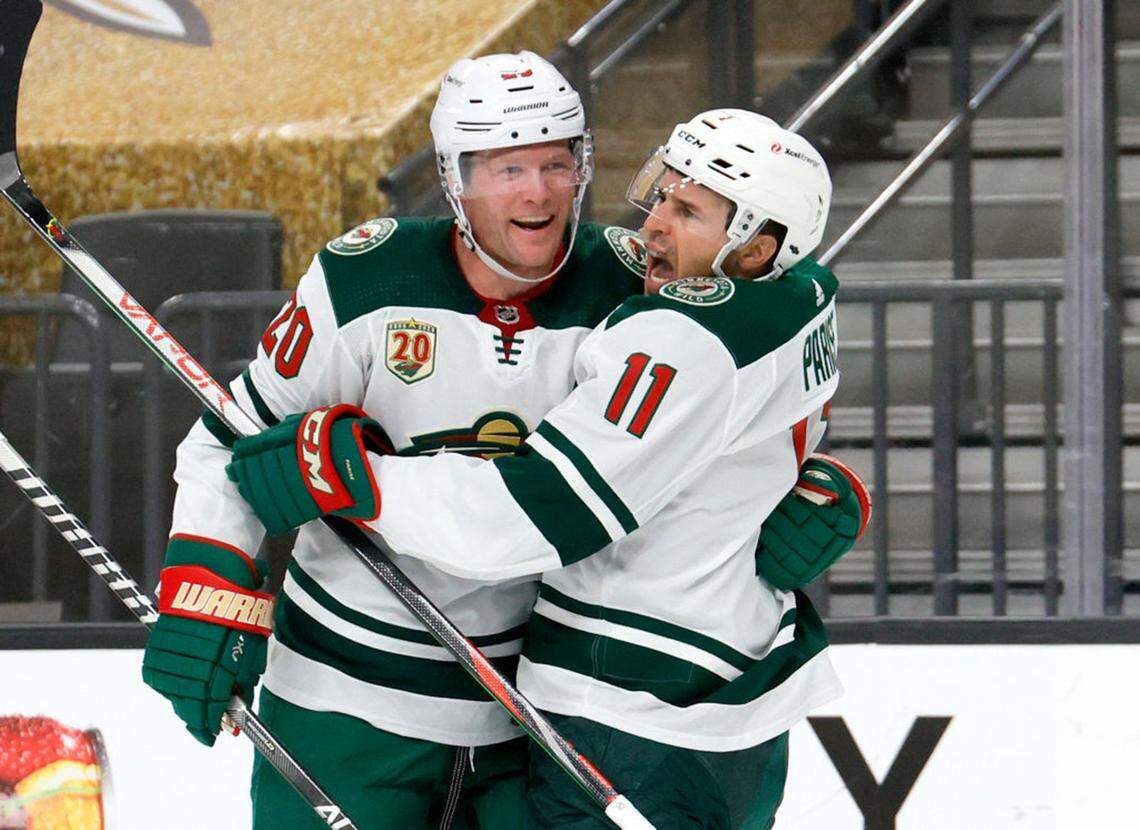 Ryan Suter #20 and Zach Parise #11 of the Minnesota Wild celebrate after Suter assisted Parise on a first-period goal against the Vegas Golden Knights in Game Seven of the First Round of the 2021 Stanley Cup Playoffs at T-Mobile Arena on May 28, 2021 in Las Vegas, Nevada. (Ethan Miller/Getty Images/TNS)