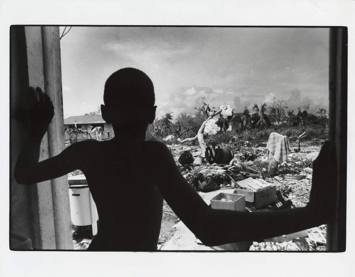 Amdre Neely, then 9, looks out from where his rear door had been in Eleuthera in the Bahamas. The door was blown off its hinges during Hurricane Andrew when it battered the Bahamas on Aug. 23, 1992, before hitting South Florida a day later.
