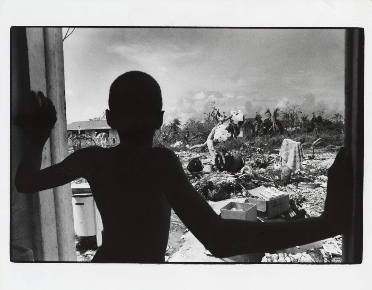 Amdre Neely, then 9, looks out from where his rear door had been in Eleuthera in the Bahamas. The door was blown off its hinges during Hurricane Andrew when it battered the Bahamas on Aug. 23, 1992, before hitting South Florida a day later.