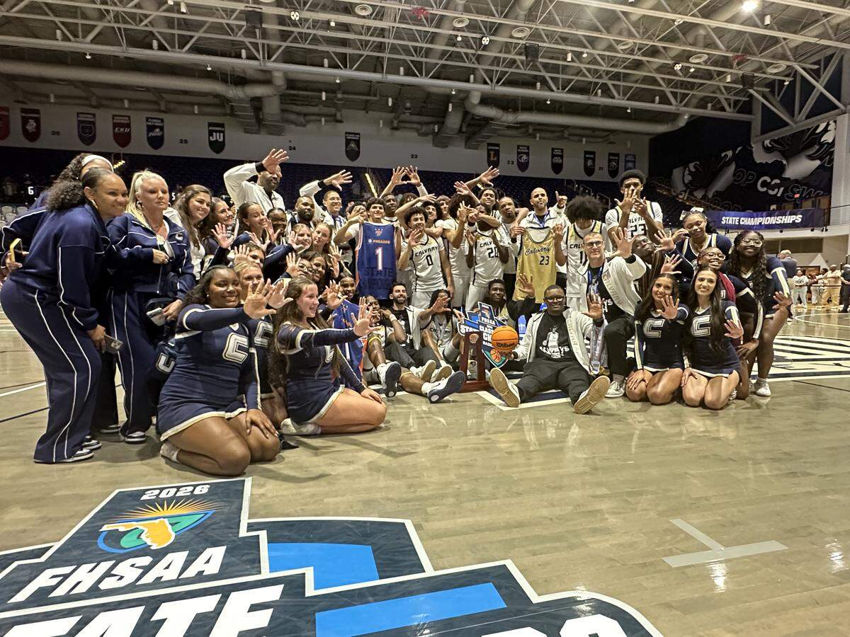 The Calvary Christian boys’ basketball team and supporters celebrate after repeating as Class 3A state champions on Wednesday night at UNF Arena in Jacksonville, Fla.