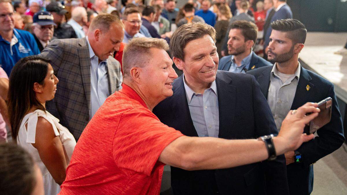 Florida Gov. Ron DeSantis greets audience members during a campaign event in Clive, Iowa, on May 30.
