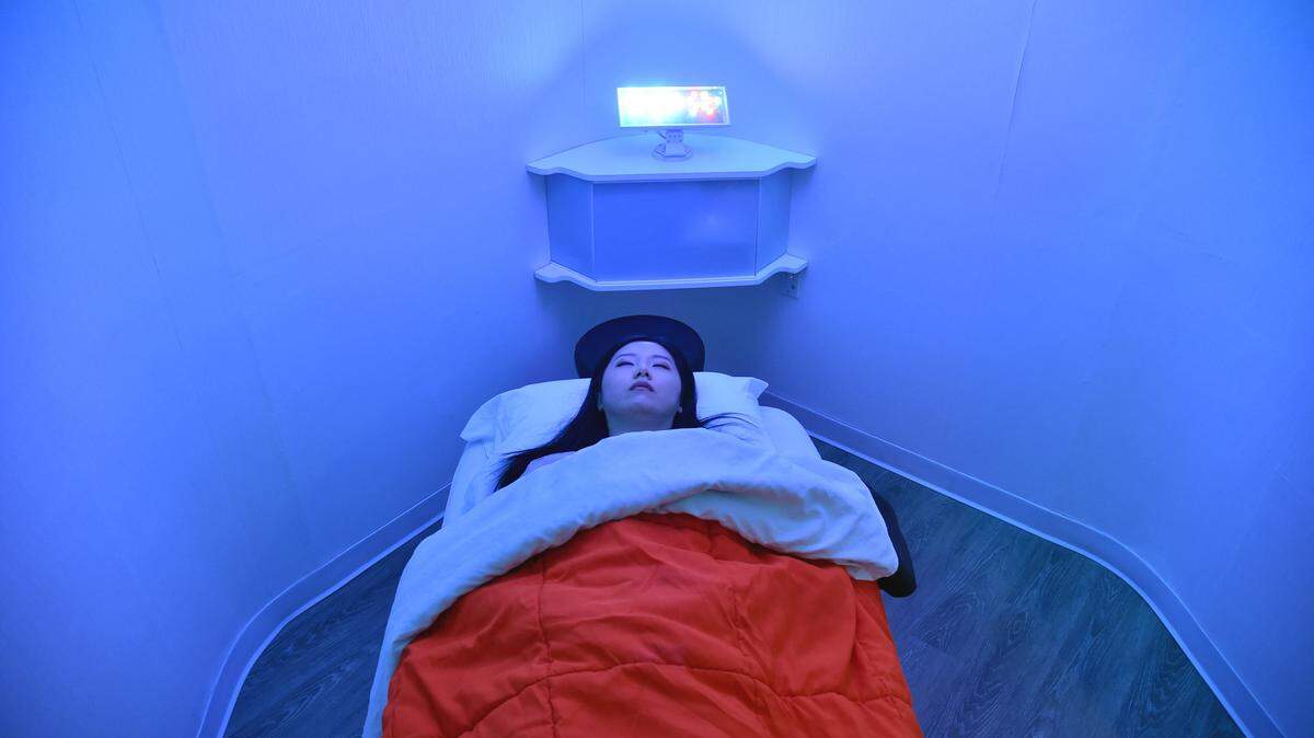 Laura Li prepares to take a nap in YeloSpa, in New York, on May 1, 2018,where New Yorkers can pay for a cabin to take a nap, and recharge energy without having to return to their homes.