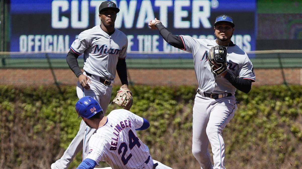 Apr 19, 2024; Chicago, Illinois, USA; Miami Marlins second baseman Luis Arraez (3) forces out Chicago Cubs outfielder Cody Bellinger (24) at second base during the first inning at Wrigley Field. Mandatory Credit: David Banks-USA TODAY Sports