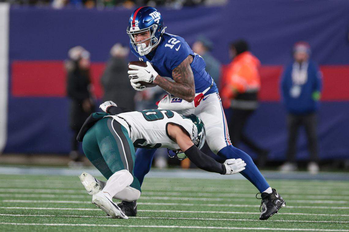 Jan 7, 2024; East Rutherford, New Jersey, USA; New York Giants tight end Darren Waller (12) is tackled by Philadelphia Eagles safety Tristin McCollum (36) during the second half at MetLife Stadium. 