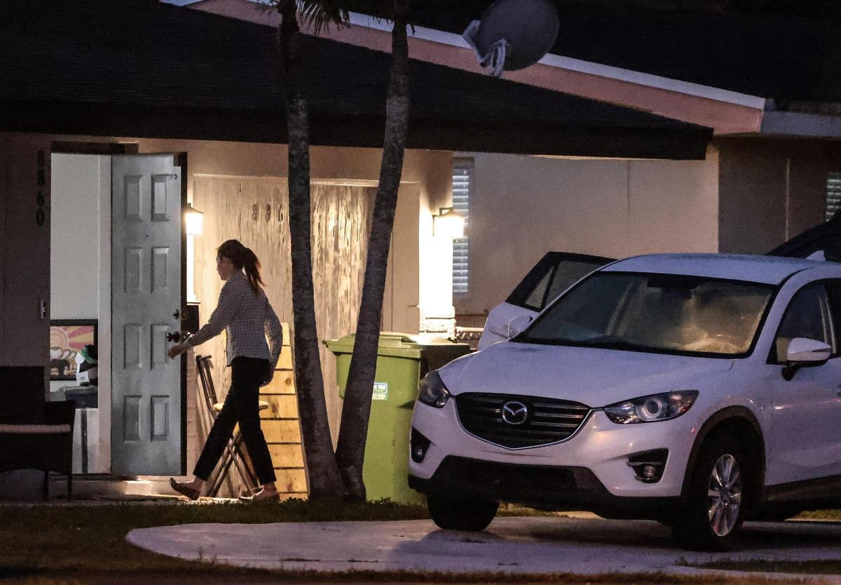 Medley Assistant Town Clerk Jenny Digiacomo heads back into her home as she prepares to leave a residence in Pembroke Pines shortly after 6 a.m. on March 8, 2022.