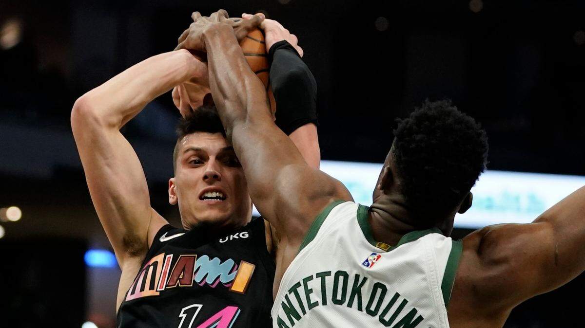 Milwaukee Bucks’ Thanasis Antetokounmpo blocks the shot of Miami Heat’s Tyler Herro during the first half of an NBA basketball game Saturday, Dec. 4, 2021, in Milwaukee.