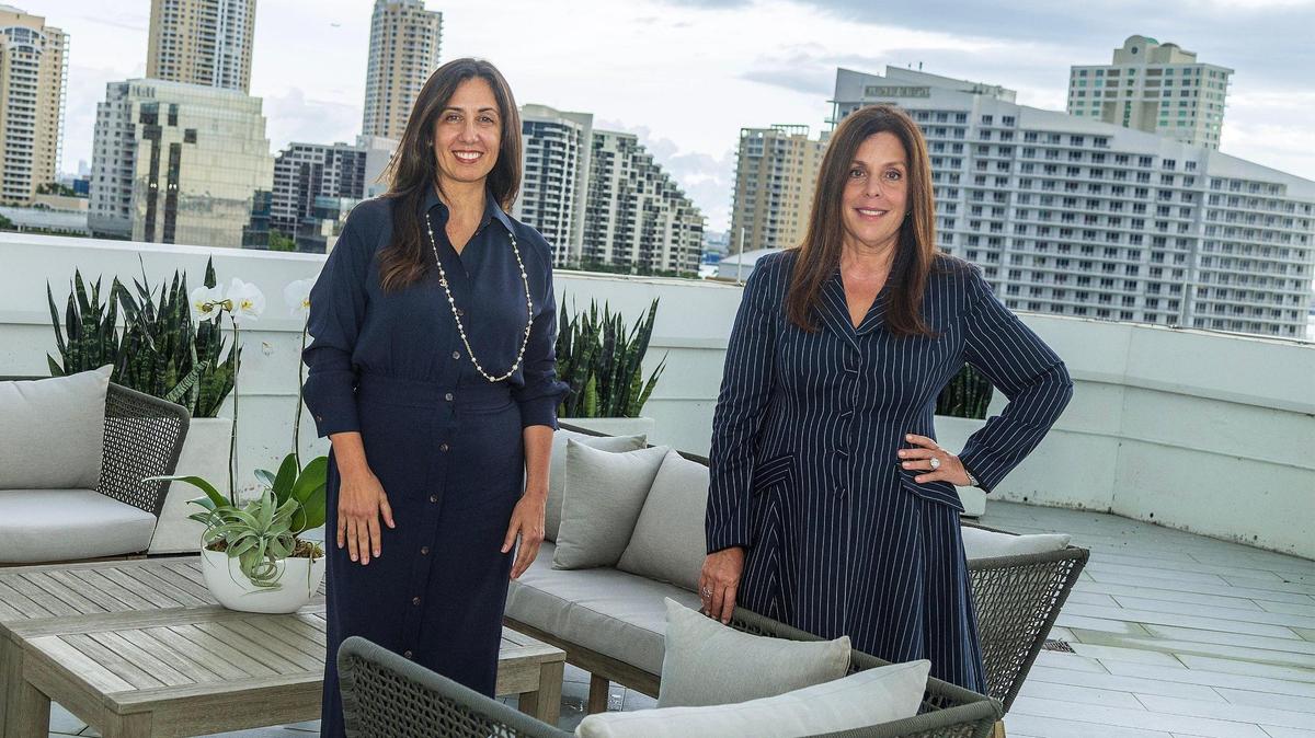 Lawyers Beatriz Azcuy, left, and Yvette Ostolaza, are partners with the multinational law firm Sidley Austin. Here they are on the terrace of the firm Miami’s office in Brickell, on Thursday Sept. 21, 2023.