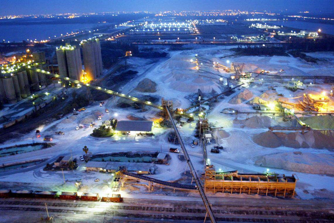 Trucks line up before sunrise to pick up and deliver sand and supplies from the Pennsuco Titan America cement plant in Miami which is operating 24 hours a day to keep up with demand. The building boom and hot real estate market have the fueled demand.