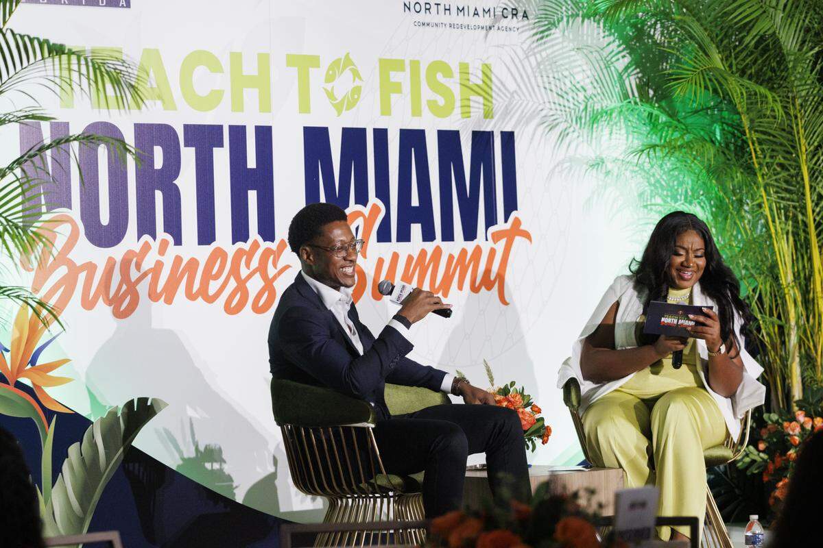 Damola Adamolekun, Red Lobster CEO, laughs while being interviewed by Vice Mayor Kassandra Timothe during the luncheon at the Teach to Fish Business Summit, on Tuesday, Oct. 14, 2025, at the Kovens Conference Center in North Miami Beach, Fla. 