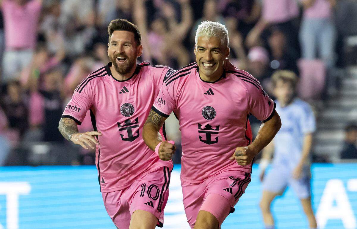 Inter Miami forward Luis Suárez (9) celebrates with forward Lionel Messi (10) after scoring a goal against Atlanta United in the first half of match one of their MLS Playoffs opening round series at Chase Stadium on Friday, Oct. 25, 2024, in Fort Lauderdale, Fla.