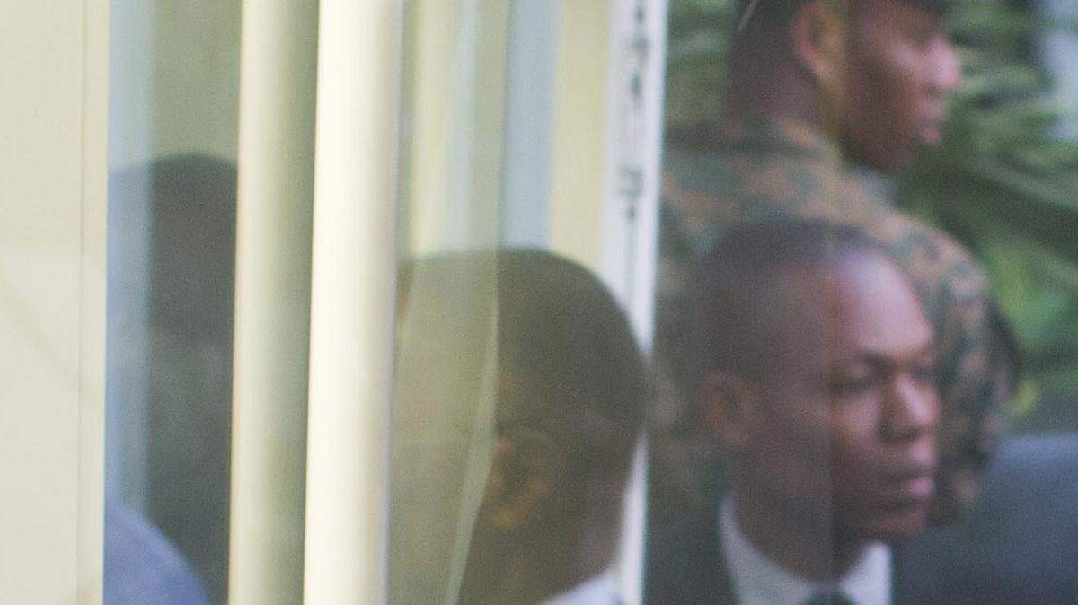 Interim President Jocelerme Privert, center, arrives with the president of the special verification commission Francois Benoit, to the national palace, in Port-au-Prince, Haiti, Monday, May 30, 2016. Haiti election officials are poised to accept the recommendations of a special verification commission calling for last year's disputed first round presidential elections to be re-run in October.