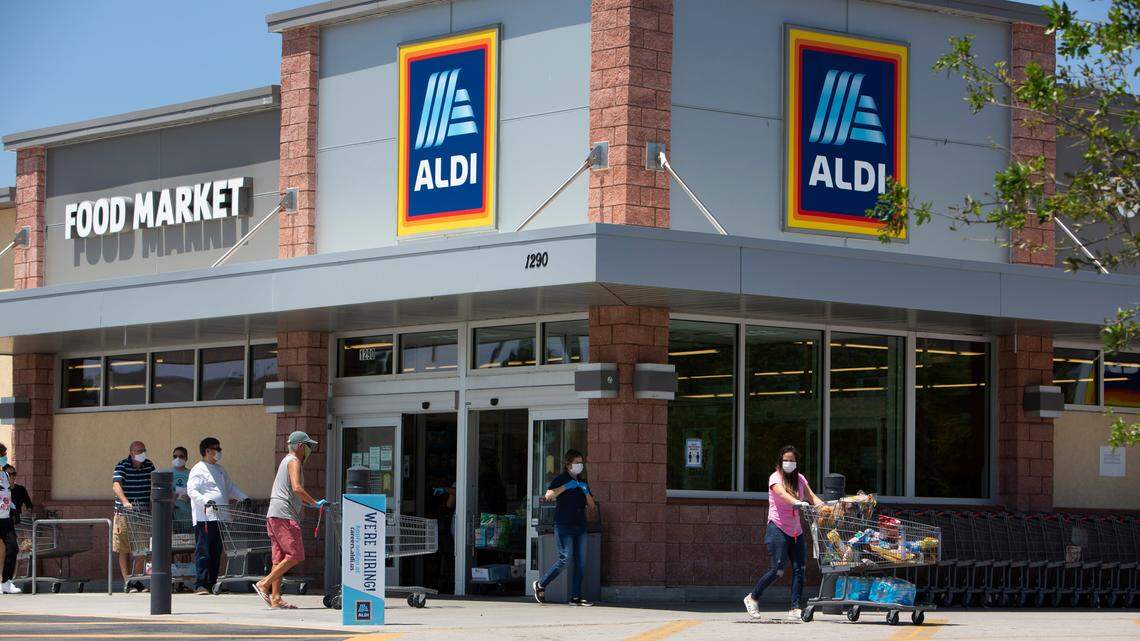 Aldi is opening three new South Florida locations this fall. Above: Shoppers at the Aldi food market, at 1290 NE 108th St., wait in line to enter the store on Wednesday, April 1, 2020.