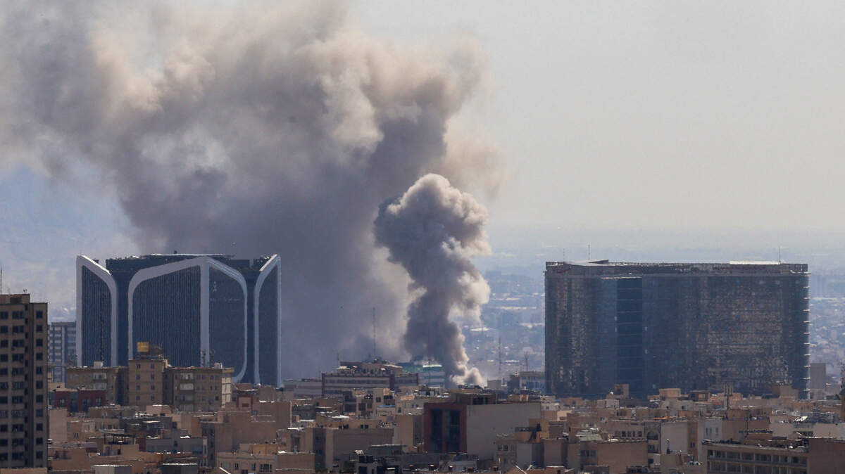Plumes of smoke rise following reported explosions in Tehran on March 1, 2026. 