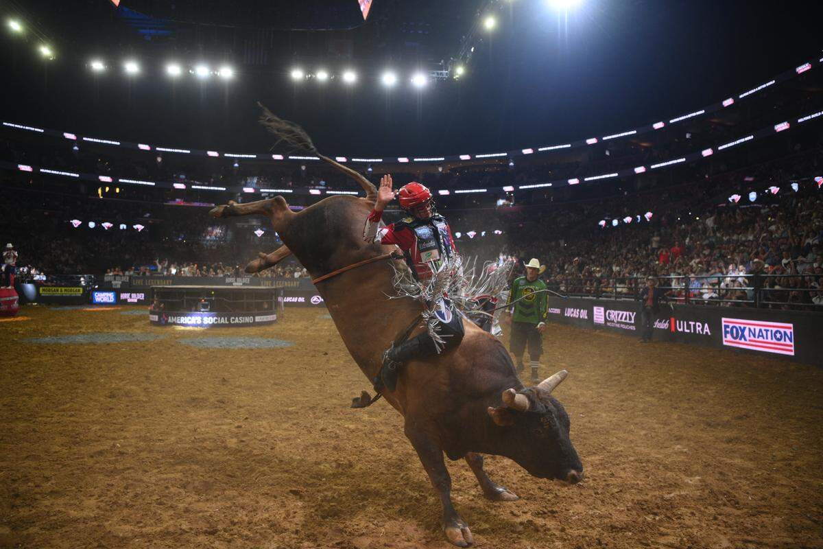 John Crimber of Florida Freedom bull riding team riding during a competition. 