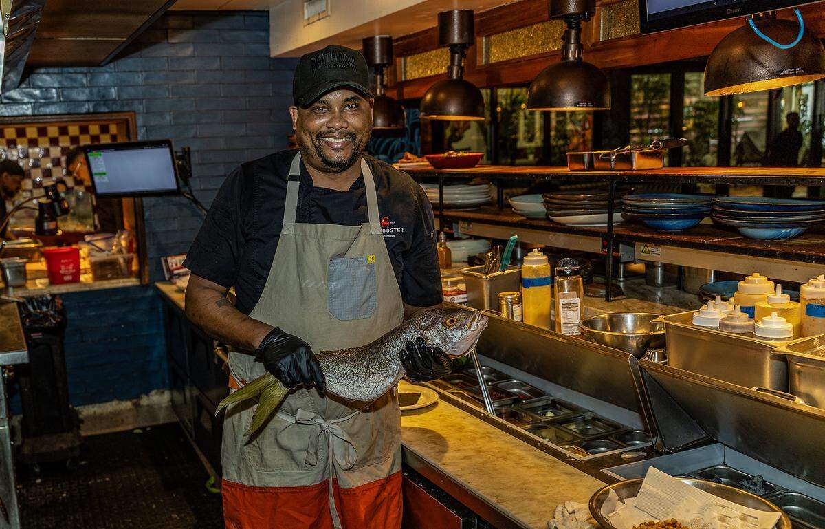 Charles Page Jr. Executive Chef gets ready to prepare a whole Snapper fish in the kitchen  at the Red Rooster restaurant located in the heart of Miami's Overtown neighborhood, on Friday, March 13, 2026.
