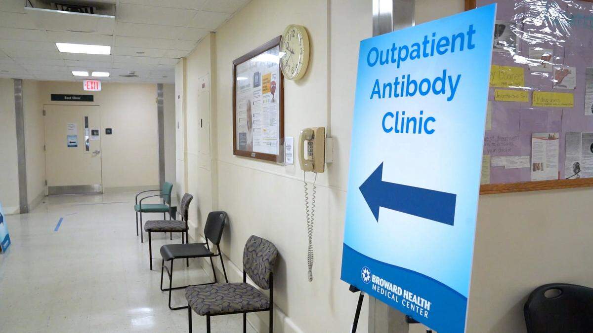 Signs direct people to Broward Health’s outpatient monoclonal antibody clinic.