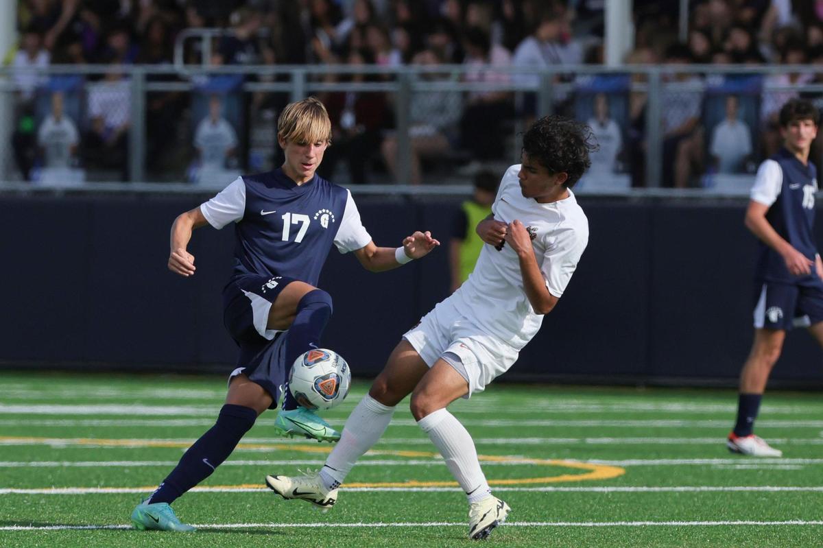 Gulliver Prep midfielder Jorge Gouvea (17) and Mater Lakes forward Carlos Sela (9) battle for the ball during the first half of the boys regional championship game at Gulliver Prep in Miami, Florida on Wednesday, February 14, 2024.