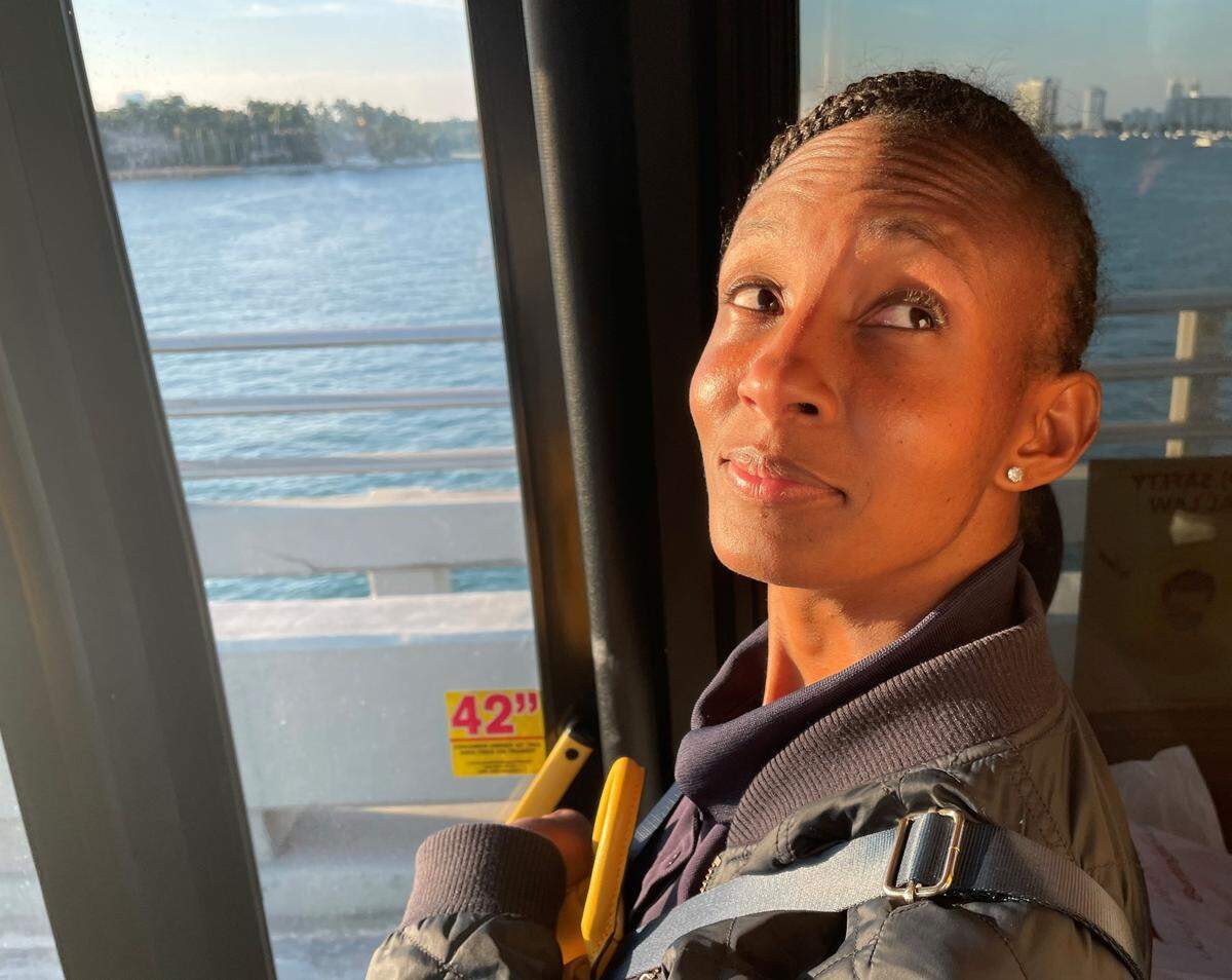 Lakeisha Henry looks up from her standing-room spot at the front of a crowded Miami-Dade County bus fighting traffic on the MacArthur Causeway as it heads west from South Beach on Wednesday, March 1, 2023. Miami-Dade County is pursuing a Metromover extension as a transit upgrade, but some on Miami Beach see the plan as rushed and risky.