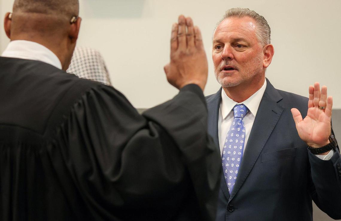 Judge Elijah H. Williams of the 7th Judicial Circuit, left, swears in Peter Licata, right, as the superintendent of Broward County Public Schools at the Kathleen C. Wright Administration Center’s boardroom in Fort Lauderdale, Florida, on Tuesday, July 18, 2023.