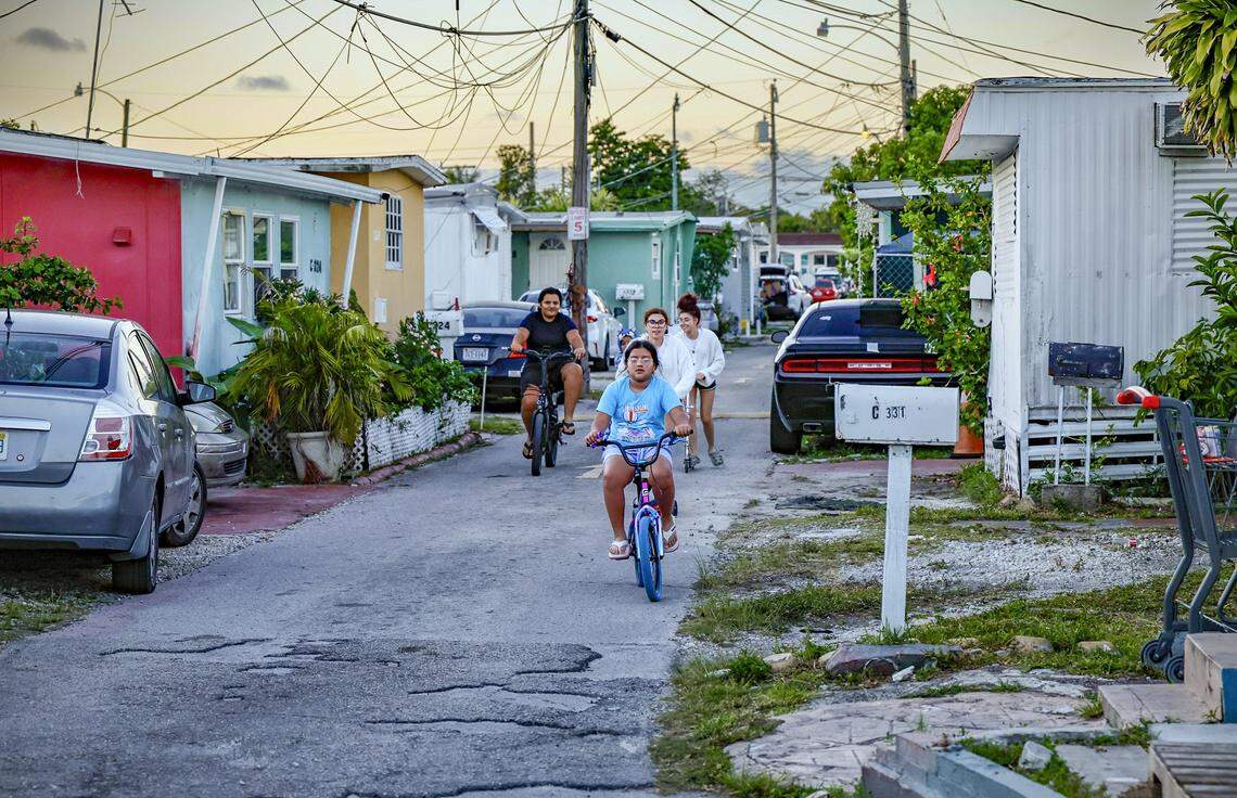 Children ride through Silver Court Mobile Home Park located at 3170 SW 8th Street in Miami, Florida, on Friday, April 17, 2026. The trailer park is closing as 200 families will soon be evicted to make room for development.