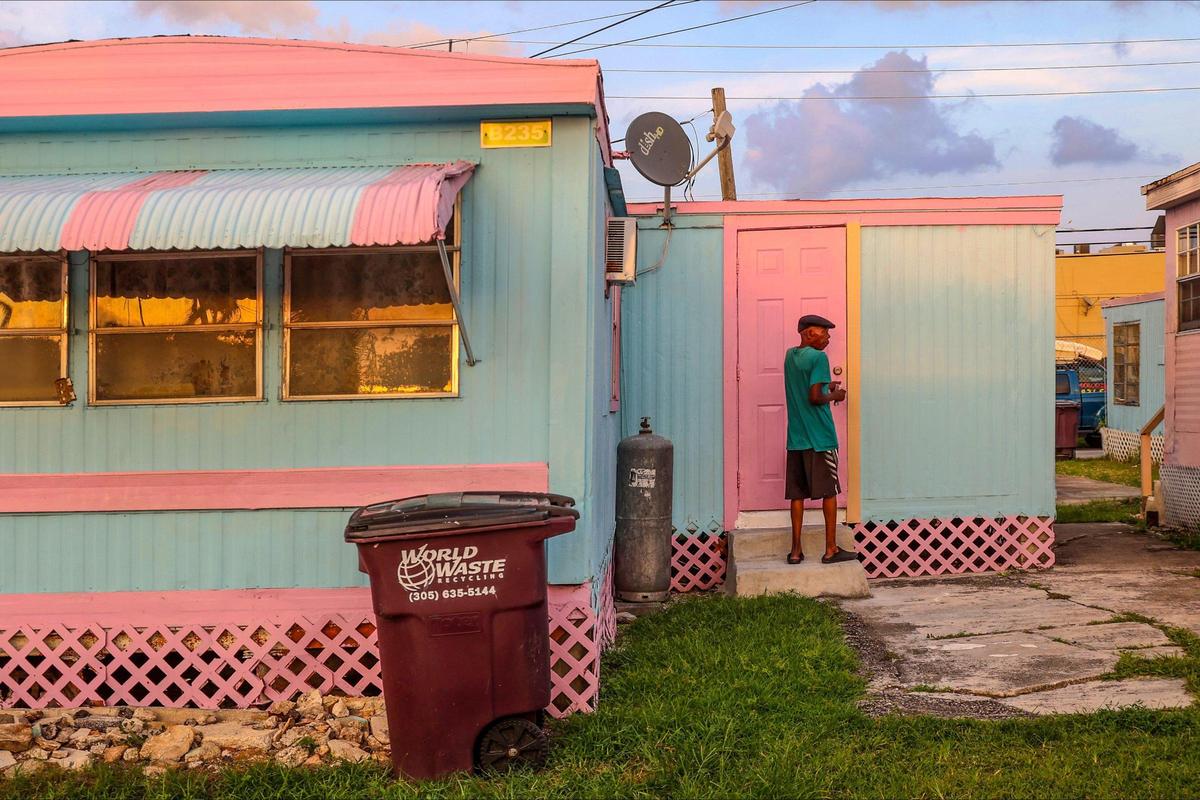 A Miami Soar resident opens the front door of his trailer while arriving home near dusk. A developer has plans to build a 50-story mixed-use development at the current site of the park.