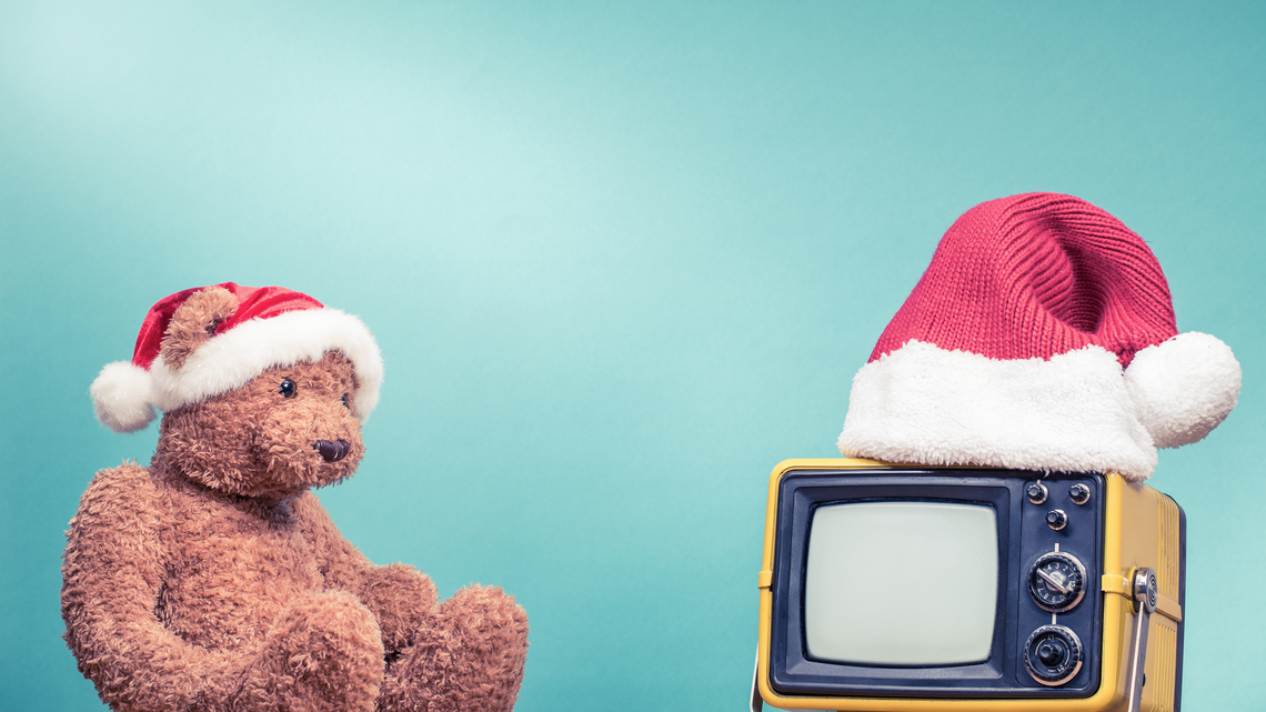 teddy bear in santa hat staring at retro tv
