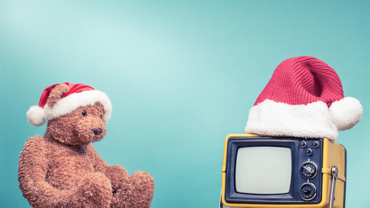 teddy bear in santa hat staring at retro tv
