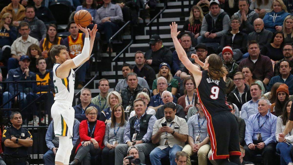 Utah Jazz guard Kyle Korver (26) shoots as Miami Heat forward Kelly Olynyk (9) defends in the first half during an NBA basketball game Wednesday Dec. 12, 2018, in Salt Lake City.
