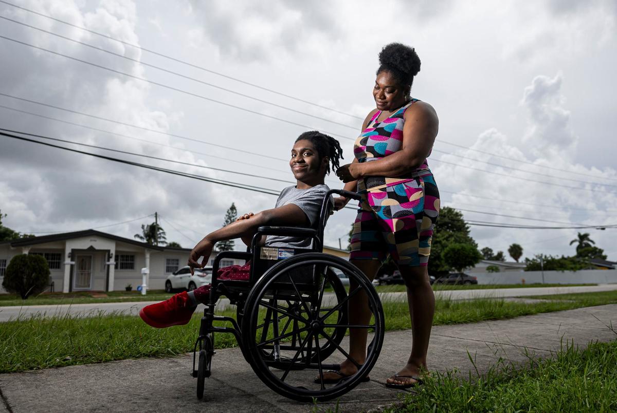 Elijah Solomon, 19, and his mother Carlene Dill, 38, are photographed outside of their home on Wednesday, Sept. 4, 2024, in Miami Gardens, Fla. Solomon, who was born with limited use of his legs, attended a driver’s education summer program at Hialeah-Miami Lakes Senior High School.