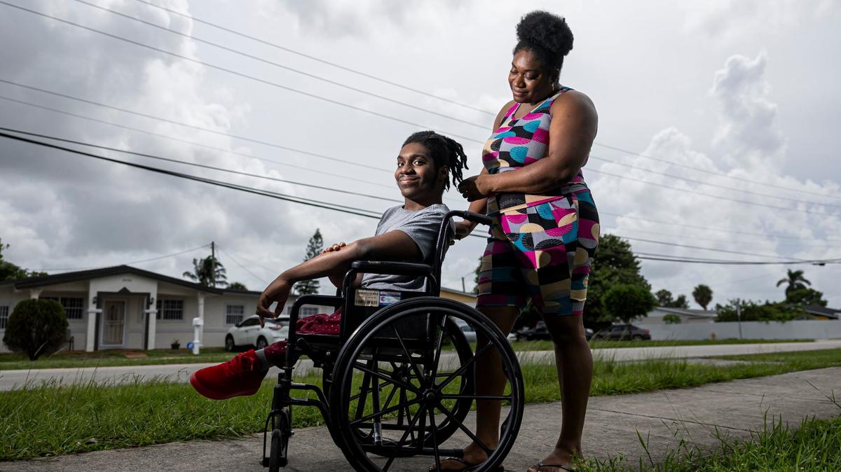 Elijah Solomon, 19, and his mother Carlene Dill, 38, are photographed outside of their home on Wednesday, Sept. 4, 2024, in Miami Gardens, Fla. Solomon, who was born with limited use of his legs, attended a driver’s education summer program at Hialeah-Miami Lakes Senior High School.