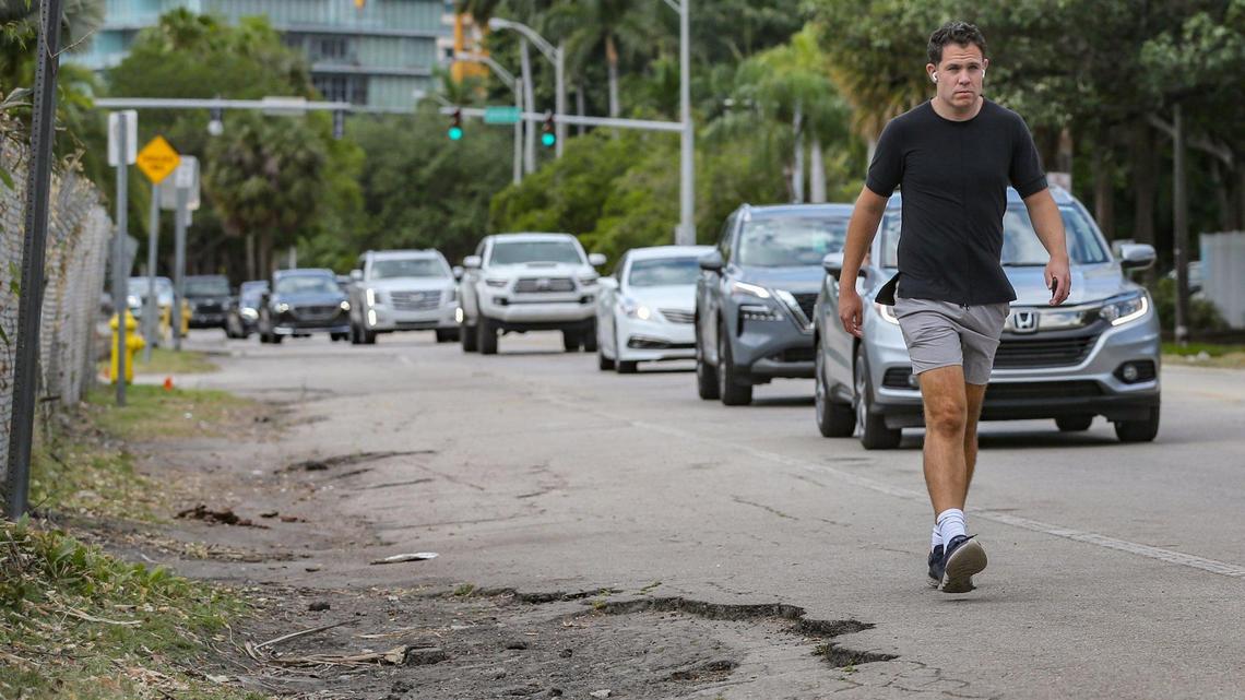 A pedestrian walking in Miami’s Coconut Grove.