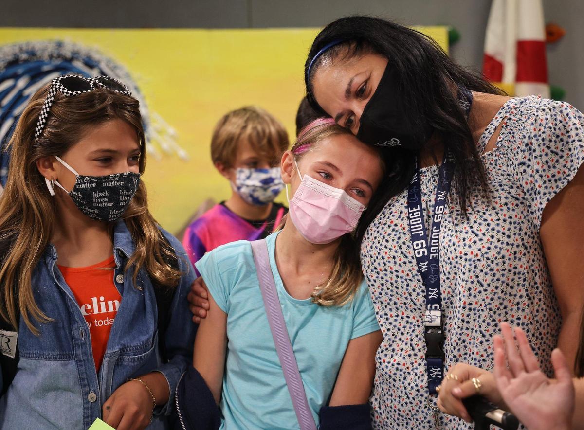 Fourth-grader Lilly Williams, 10, center, tears up while saying goodbye to her iPrep Academy teacher, Elizabeth Martinez, right, for the summer. Superintendent Alberto Carvalho recapped all the challenges of the school year on Wednesday, June 9, 2021, the last day of school for Miami-Dade Schools students.