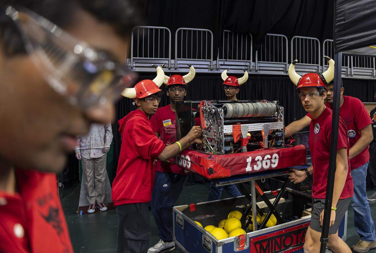 Middleton High School student Anderson Sears, 16, right, a member of Minotaur, helps push his team’s robot, Endeavor, as they prepare to compete in the 2026 FIRST Robotics South Florida Regional Competition at the University of Miami’s Watsco Center on Friday, April 10, 2026, in Coral Gables, Fla. Participants from local school districts, surrounding states, and international teams are competing for an opportunity to earn a spot at the 2026 FIRST World Championship.