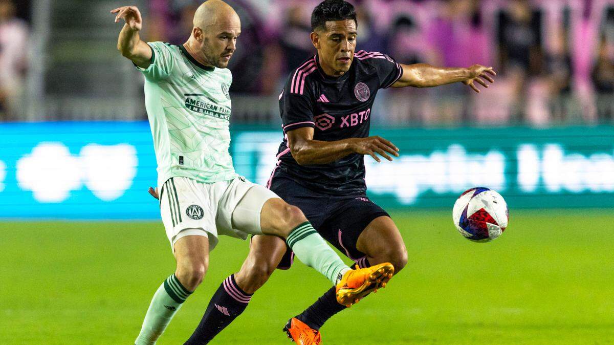 Inter Miami CF midfielder Victor Ulloa (13) fights for possession of the ball with Atlanta United defender Andrew Gutman (15) during the second half of an MLS game at DRV PNK Stadium in Fort Lauderdale, Florida, on Saturday, May 6, 2023.