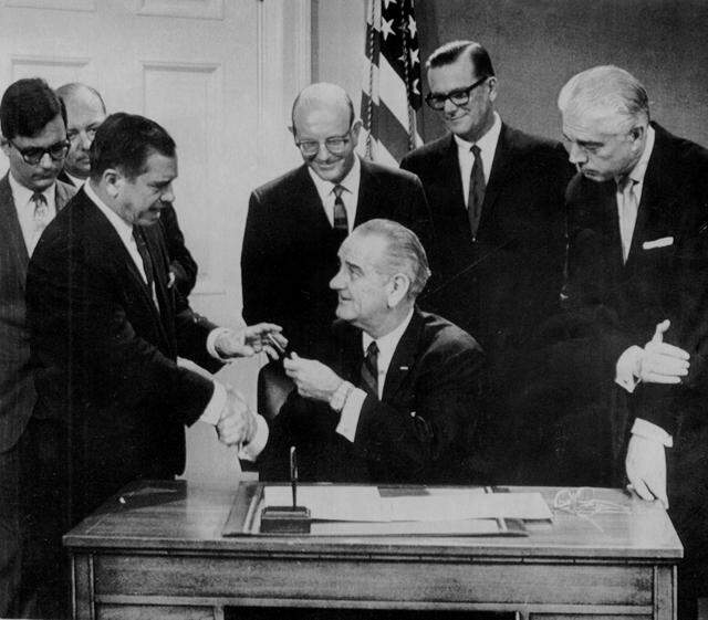 President Johnson gives his pen to U.S. Rep. Dante Fascell at the White House in 1968 after signing a bill establishing a national monument in Biscayne Bay. In 1980, the monument was expanded and designated a national park. In the background, from left, Joseph Browder of the National Audubon Society; Davis Early (partly hidden) of the Florida Development Commission; Lloyd Miller of the Izaac Walton League; R. Hardy Matheson, Dade County Commissioner; and Mayor Chuck Hall of Dade County.